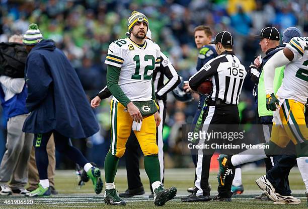 Quarterback Aaron Rodgers of the Green Bay Packers walks off the field during the 2015 NFC Championship game against the Seattle Seahawks at...
