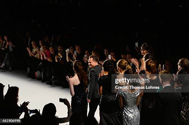 Designer Guido Maria Kretschmer and models walk the runway at the Guido Maria Kretschmer show during the Mercedes-Benz Fashion Week Berlin...