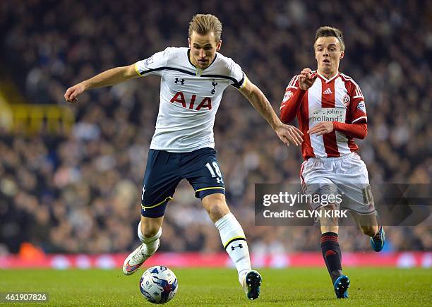 Sheffield United's Scottish midfielder Stefan Scougall challenges Tottenham Hotspur's English striker Harry Kane during the English League Cup...