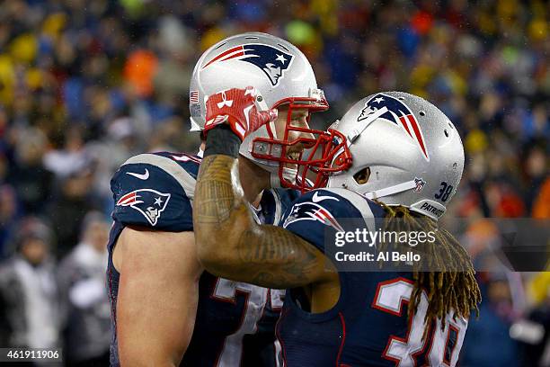 Nate Solder of the New England Patriots celebrates scoring a touchdown in the third quarter with teammate Brandon Bolden against the Indianapolis...