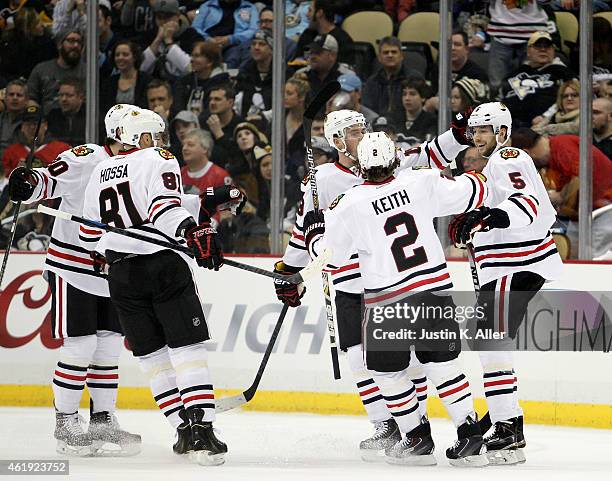 David Rundblad of the Chicago Blackhawks celebrates his first period goal with teammates in the first period during the game at Consol Energy Center...