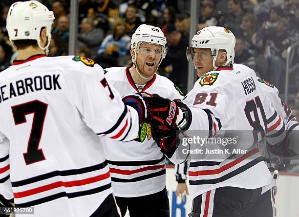 Marian Hossa celebrates after scoring in the second period with Bryan Bickell and Brent Seabrook of the Chicago Blackhawks during the game against...