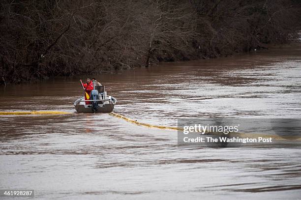 Emergency crew try to position booms to contain the chemical leak in the Elk River on Saturday, January 11, 2014 at the West Virginia American Water...