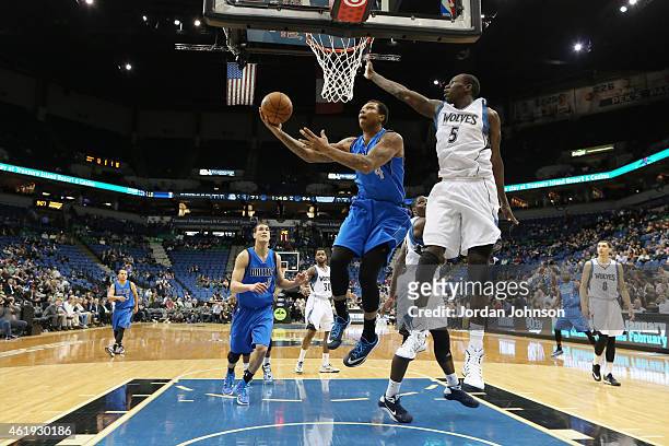 Greg Smith of the Dallas Mavericks hooks the ball from under the basket against the Minnesota Timberwolves during the game on January 21, 2015 at...