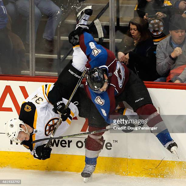 Jan Hejda of the Colorado Avalanche puts a hit on Carl Soderberg of the Boston Bruins and up ends him at Pepsi Center on January 21, 2015 in Denver,...