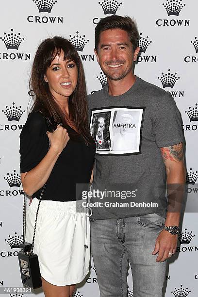 Harry Kewell and his wife Sheree Murphy pose as they arrive at the IMG tennis players party at Crown Towers on January 12, 2014 in Melbourne,...