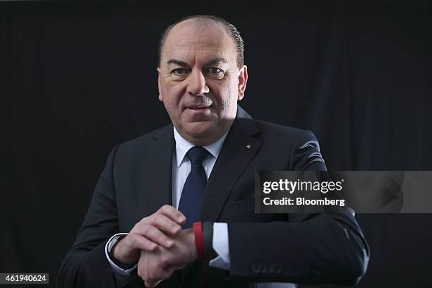 Axel Weber, chairman of UBS Group AG, poses for a photograph with his red Fitbit Inc. Wearable fitness device following a Bloomberg Television...