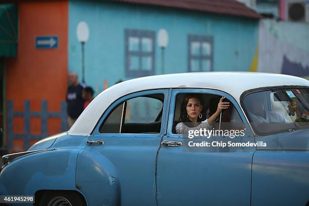 Woman sits in the front seat of a independent taxi in Centro Habana, the neighborhood with the highest population density in the capital city,...