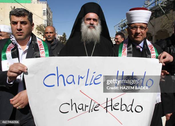 Palestinian Greek Orthodox Archbishop Atallah Hanna walks beside Sheikh Hatem al-Bakri in a demonstartion on January 22, 2015 in the West Bank city...