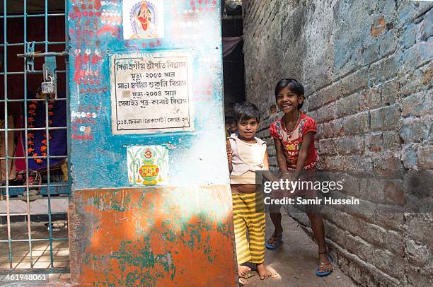 Children play in a slum on December 9, 2013 in Kolkata, India. Almost one third of the Kolkata population live in slums and a further 70,000 are...