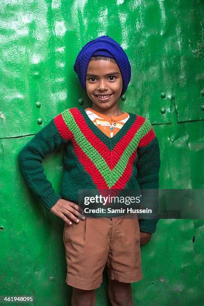 Boy poses in a slum on December 10, 2013 in Kolkata, India. Almost one third of the Kolkata population live in slums and a further 70,000 are...