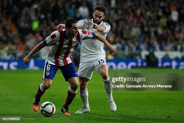 Koke of Atletico de Madrid competes for the ball with Daniel Carvajal of Real Madrid CF during the Copa del Rey Round of 16 second leg match between...