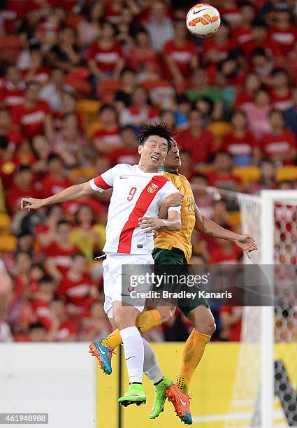 Yang Xu of China and Trent Sainsbury of Australia challenge for the ball during the 2015 Asian Cup match between China PR and the Australian...