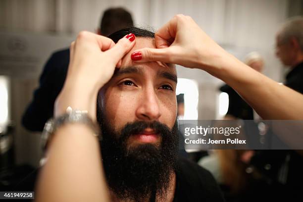 Model is seen getting styled backstage ahead of the Vektor show during the Mercedes-Benz Fashion Week Berlin Autumn/Winter 2015/16 at Brandenburg...