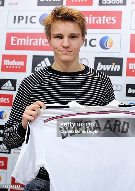 Martin Odegaard from Norway holds his new Real Madrid shirt during a press conference at Real Madrid's Valdebebas training grounds after he signed...