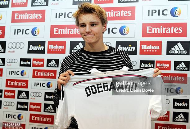 Martin Odegaard from Norway holds his new Real Madrid shirt during a press conference at Real Madrid's Valdebebas training grounds after he signed...