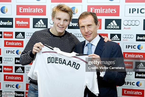 Martin Odegaard from Norway holds his new Real Madrid shirt with former Real Madrid player Emilio Butragueno during his official presentation at the...