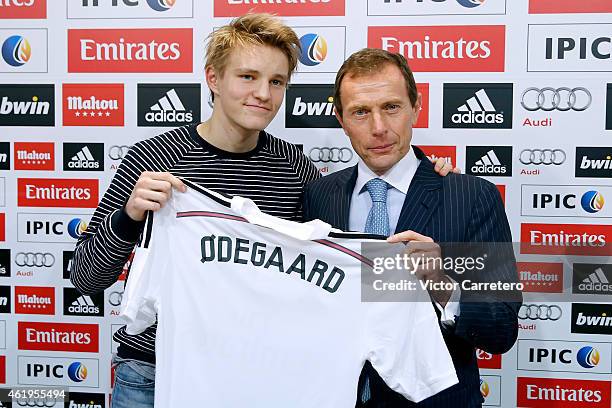 Martin Odegaard from Norway holds his new Real Madrid shirt with former Real Madrid player Emilio Butragueno during his official presentation at the...