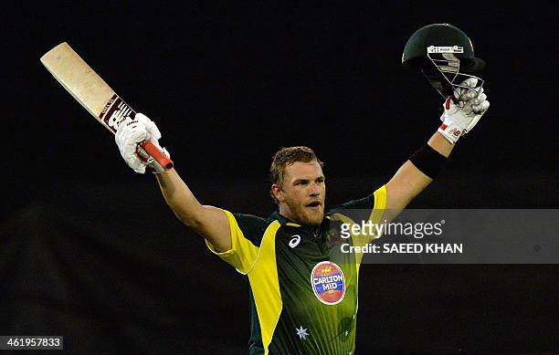 Australia's batsman Aaron Finch celebrates scoring a century during the first one day international cricket match of the series between Australia and...