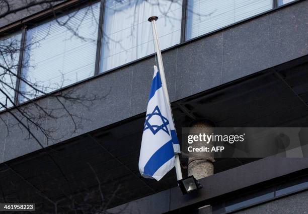 The Israeli flag flies at half-mast at the Israeli embassy in The Hague, on January 12 in memory of late former Israeli prime minister Ariel Sharon....