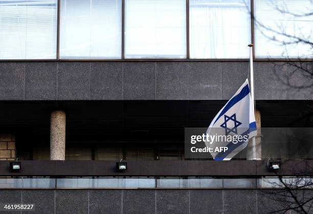 The Israeli flag flies at half-mast at the Israeli embassy in The Hague, on January 12 in memory of late former Israeli prime minister Ariel Sharon....