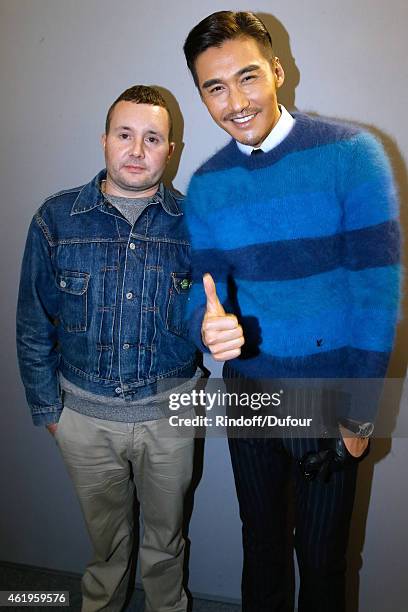 Fashion designer Kim Jones and Model and actor Hu Bing pose backstage after the Louis Vuitton Menswear Fall/Winter 2015-2016 Show as part of Paris...