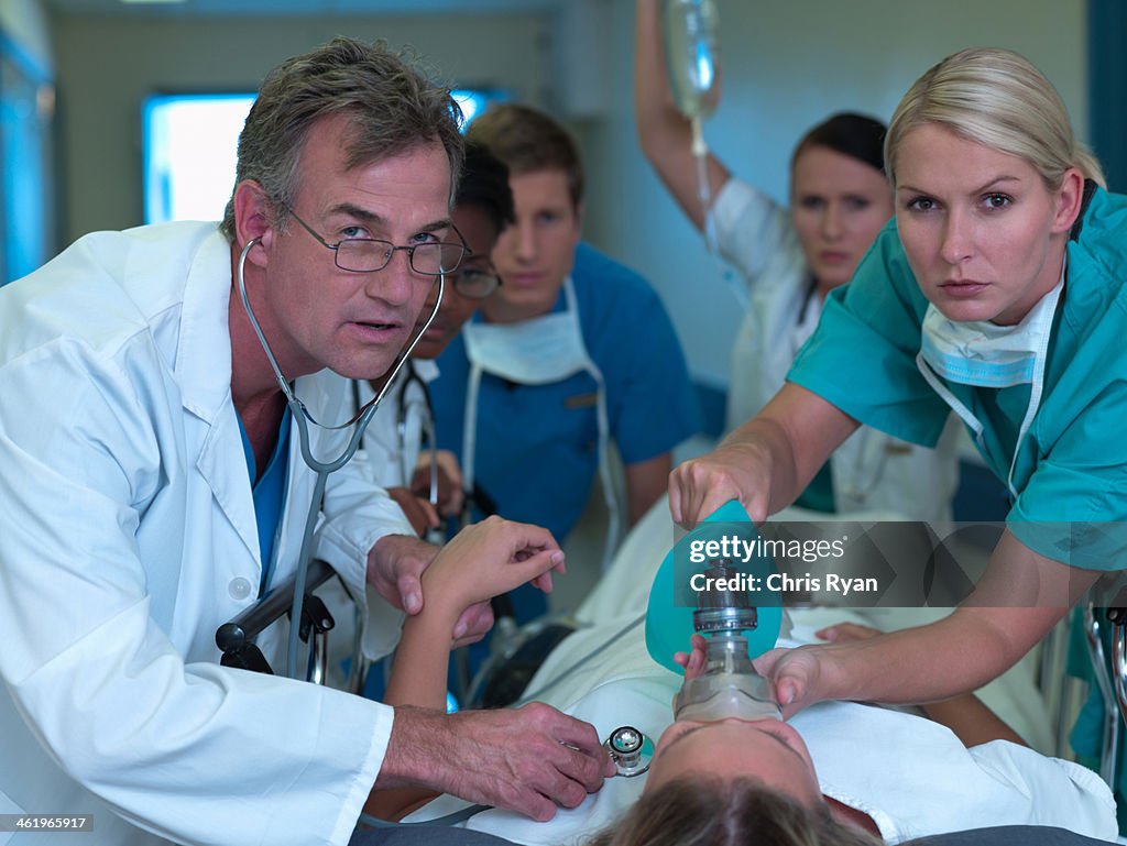 Doctor Rushing Patient In Doctors And Nurses Rushing With Patient In Hospital High-Res Stock ...