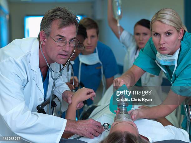 doctors and nurses rushing with patient in hospital - chris dangerous stock pictures, royalty-free photos & images