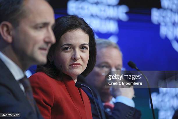 Sheryl Sandberg, billionaire and chief operating officer of Facebook Inc., center, and Eric Schmidt, chairman of Google Inc., right, listen as Jim...