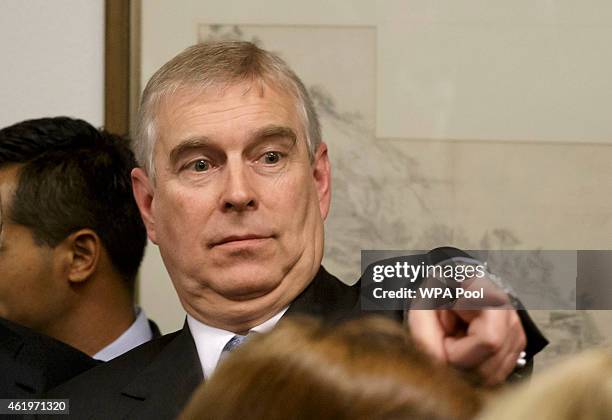 Prince Andrew, Duke of York points his finger as he speaks to business leaders during a reception at the sideline of the World Economic Forum on...