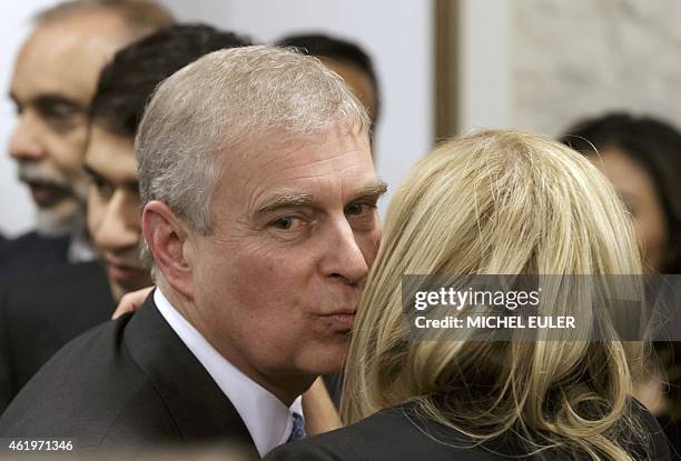 Britain's Prince Andrew greets a delegate during a reception with business leaders on the sidelines of the World Economic Forum in Davos on January...