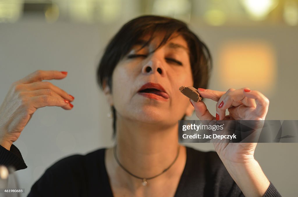 Woman eating chocolate with ecstatic expression