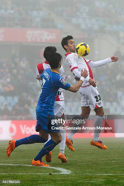 Alberto Bueno of Rayo Vallecano de Madrid saves a chest before Angel Lafita of Getafe CF during the La Liga match between Getafe CF and Rayo...