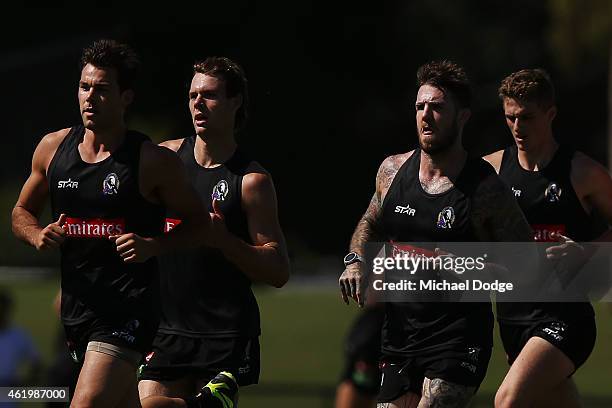 Levi Greenwood Dane Swan and Matt Scharenberg run hard during a Collingwood Magpies AFL training session at Olympic Park on January 23, 2015 in...