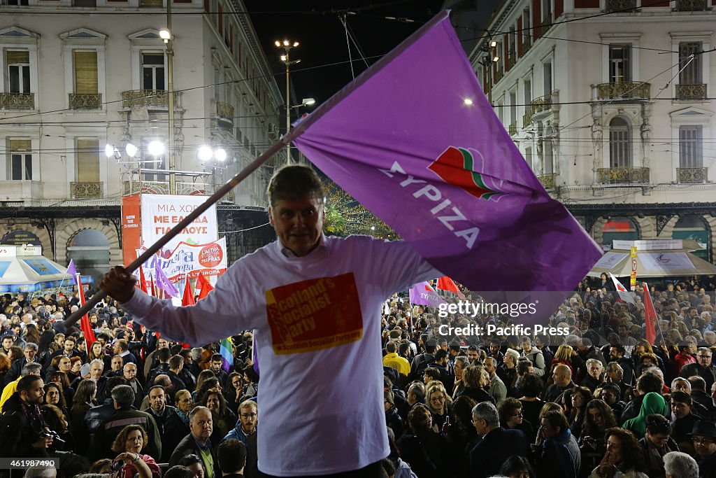 Colin Fox from the Scottish Socialist Party waves a SYRIZA...