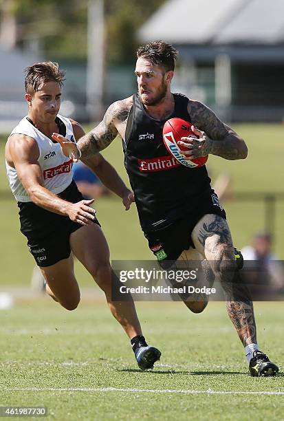 Dane Swan runs with the ball away from Ben Kennedy during a Collingwood Magpies AFL training session at Olympic Park on January 23, 2015 in...