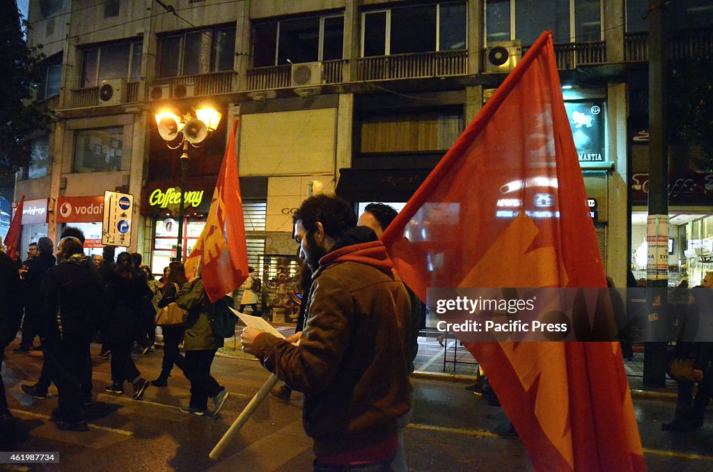 KKE supporters march through the streets of Athens carrying...