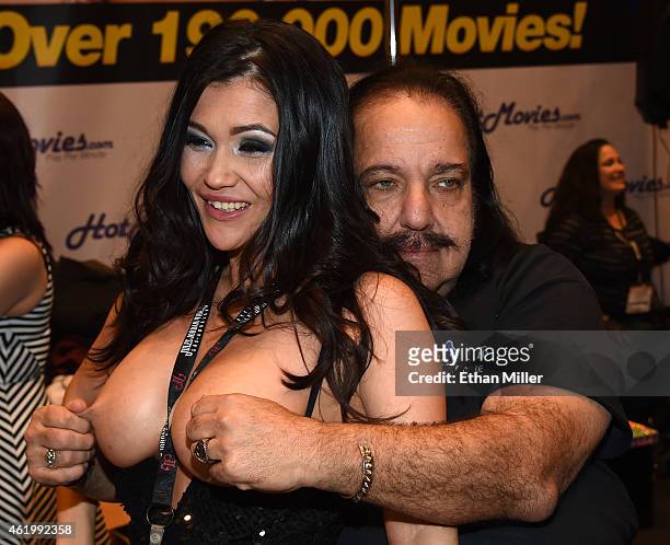 Adult film actress Kiana Bradley jokes around with adult film actor Ron Jeremy at the HotMovies.com booth at the 2015 AVN Adult Entertainment Expo at...