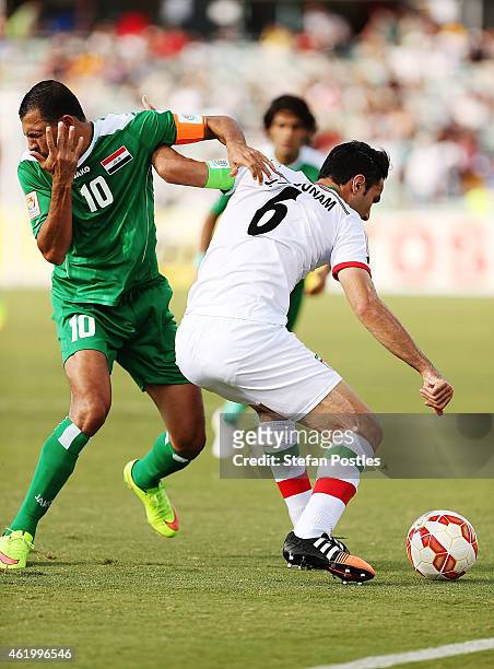 Younus Mahmood of Iraq reacts after receiving an elbow in the face from Javad Nekonam of Iran during the 2015 Asian Cup match between Iran and Iraq...