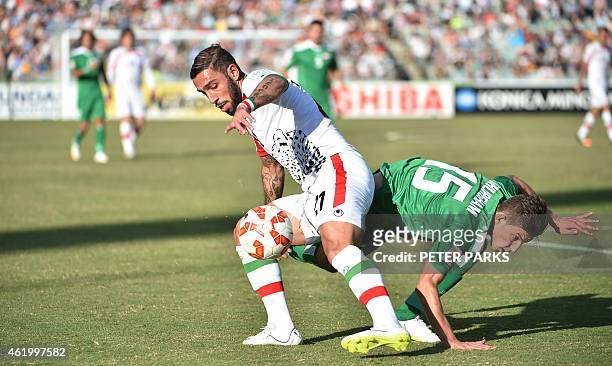 Ashkan Dejagah of Iran and Dhurgham Ismael of Iraq fight for the ball during their AFC Asian Cup quarter-final football match in Canberra on January...
