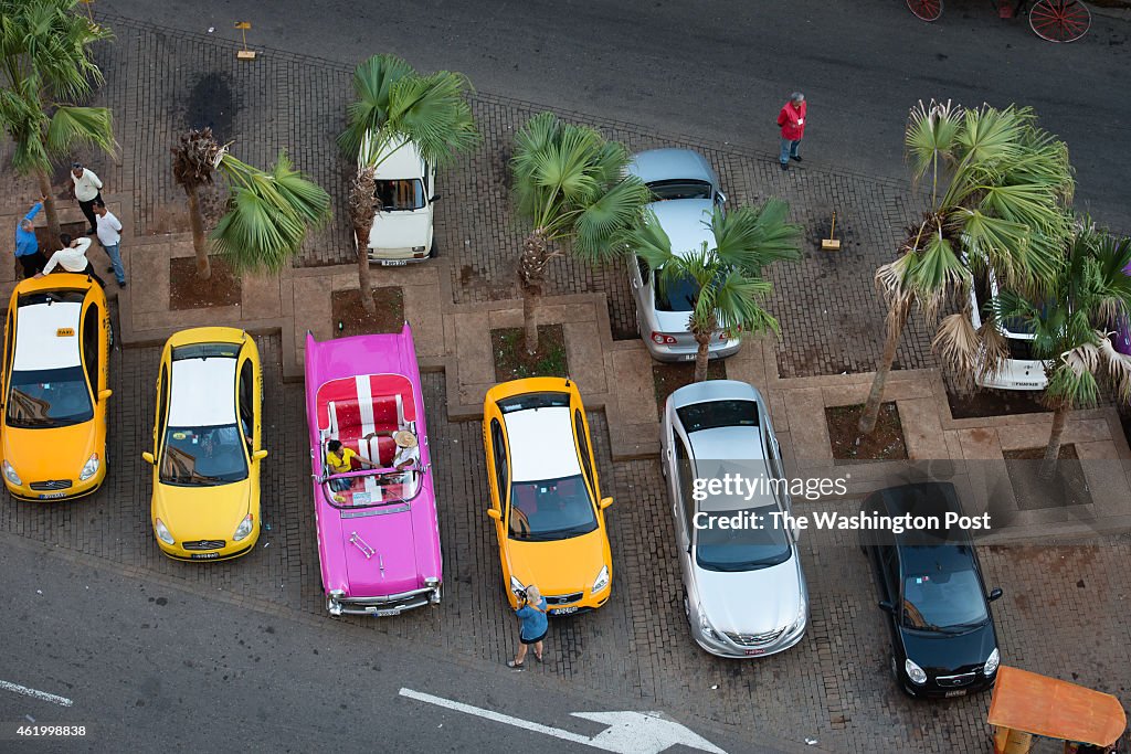 HAVANA,  - JANUARY 21: Taxi drivers are pictured soliciting bus