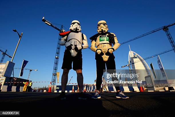 Runners pose in front of Bur Al Arab during the Standard Chartered Dubai Marathon on January 23, 2015 in Dubai, United Arab Emirates.