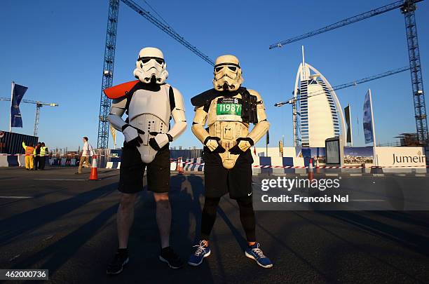 Runners pose in front of Bur Al Arab during the Standard Chartered Dubai Marathon on January 23, 2015 in Dubai, United Arab Emirates.