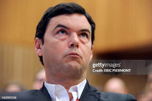 France's influential economist Thomas Piketty, author of the bestseller "Capital in the 21st Century", listens prior to address a keynote speech...