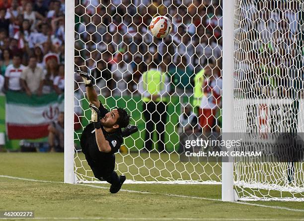 Goalkeeper Alireza Haghighi of Iran misses the ball during the penalty shootout during the Asian Cup quarter-final football match between Iraq and...