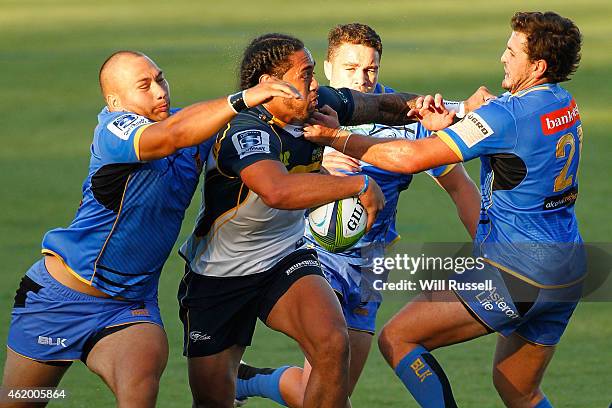Joe Tomane of the Brumbies is tackled by Robbie Abel, Kane Koteka and Robbie Abel of the Force during the Super Rugby trial match between Western...
