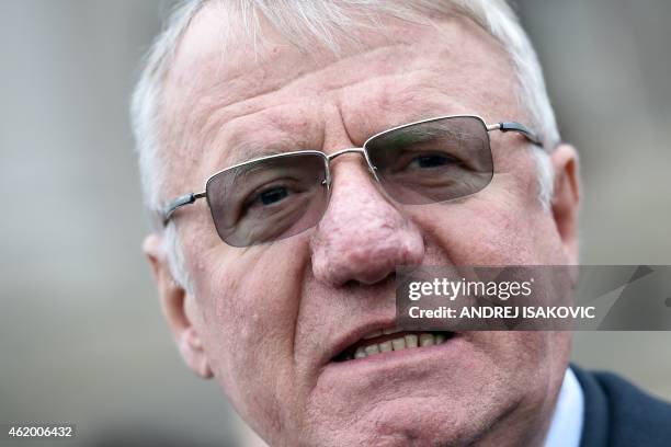 Serbian nationalist politician Vojislav Seselj speaks to journalists in front of the Serbian parliament building in Belgrade on January 23, 2015....