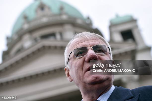 Serbian nationalist politician Vojislav Seselj speaks to journalists in front of the Serbian parliament building in Belgrade on January 23, 2015....