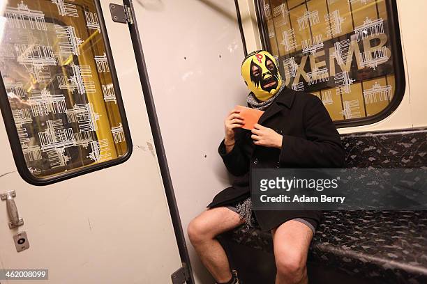 Participant of the No Pants Subway Ride wearing a luchador, or Mexican wrestler, mask rides a train on January 12, 2014 in Berlin, Germany. The...