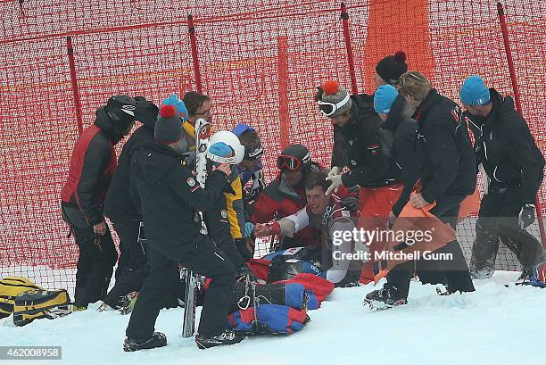 Marc Gisin of Switzerland is treated for facial injuries after crashing out during the Audi FIS Alpine Ski World Cup Super-G race on January 23, 2015...